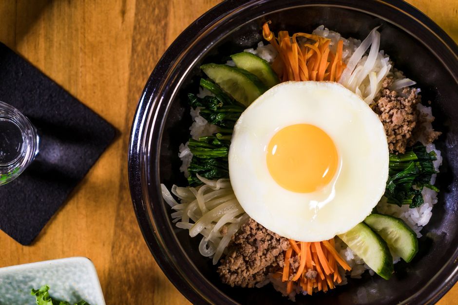 Bibimbap — Rice topped with seasoned vegetables, meat and egg.
