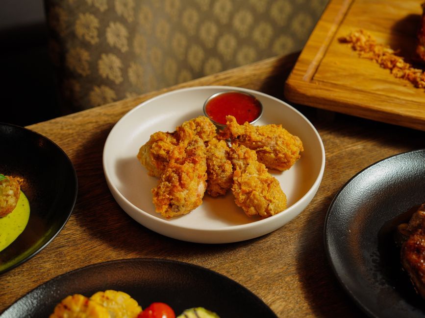 Chicken Wings — Whole wings, fried or baked, usually sauced or dry-rubbed.