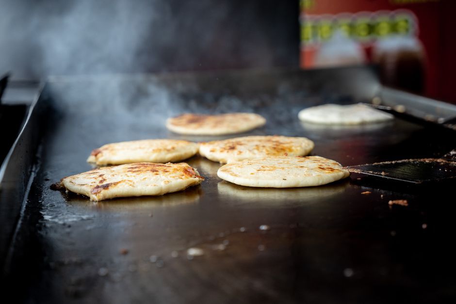 Pupusas — Thick griddled corn cakes stuffed with cheese, beans or pork.